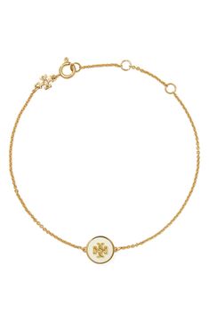 A polished Tory Burch logo set in a lacquered charm brings signature sophistication to a delicate chain bracelet. 6 3/4" length; 1 1/2" extender 18k-gold plate/acrylic/moonstone Imported White Formal Jewelry With Logo Charm, Formal White Jewelry With Logo Charm, Classic Yellow Gold Jewelry With Logo, Classic Adjustable Jewelry With Logo Charm, Tory Burch Candle, Tory Burch Hoop Earrings, Tory Burch Jewelry Gold, Tory Burch Ivory Bags, Apple Watch Wristbands