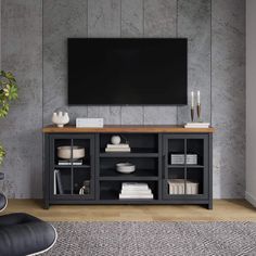 a living room with a large flat screen tv on the wall and shelves below it