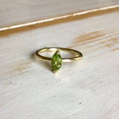 Beautiful in all its simplicity. This would make a lovely addition to anyone's jewellery collection. Or be perfect to pop the question with. A simple and stunning design made to wow that special person in your life. This single stone ring is made in 18 carat yellow gold and is set with a Marquise or Navette cut Peridot. Polished to a high sheen.  The Peridot is set in a lovely open two claw setting which really gives the stone a lovely sparkle by allowing light to transfer through the stone.The Gold Peridot Ring, Peridot Engagement Ring, Marquise Engagement Ring, Engagement Ring Marquise, Peridot Engagement Rings, Rose Gold Morganite Ring, Single Stone Ring, Rose Gold Morganite, Peridot Jewelry