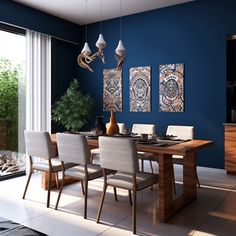 a dining room with blue walls and artwork on the wall, along with white chairs