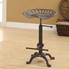 an adjustable stool sits on the floor in front of a basket