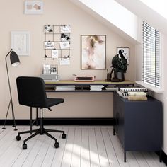 an office with a desk, chair and pictures on the wall above it's desk