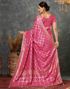 Bright Pink Woven Banarasi Cotton Saree  Bright Pink Woven Banarasi Cotton Saree is a unique and comfortable piece. The intricate weaving patterns, often featuring floral motifs or geometric designs, create a rich and textured fabric. The cotton base adds a touch of breathability and softness, making it perfect for warmer weather.  Features Of Bright Pink Woven Banarasi Cotton Saree  Traditional Handloom Craft  Intricate Gold Brocade Work  Durability and Longevity   Size Fit  The model height is Pink Unstitched Saree With Printed Motifs, Pink Bollywood Cotton Saree, Pink Saree With Woven Motifs, Semi-stitched Pink Banarasi Silk Saree, Pink Semi-stitched Cotton Silk Pre-draped Saree, Saree Traditional, Navratri Special, Gold Brocade, Textured Fabric