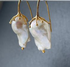 Large freshwater iridescent white baroque pearl drop earrings for women in 18k gold plated on 925 sterling silver that would make a real statement on your wedding day! With amazingly beautiful lustre and aaa grade, these elegant earrings would make exquisite jewelry gifts for a bride or mother of the bride or groom These high quality cultured pearls come naturally in different shapes but these pairs have been bought specially as a closely matched pair. The natural variations in shape adds to the Handmade Baroque Pearl Drop Earrings, Formal Single Baroque Pearl Earring, Delicate Baroque Pearl White Earrings, Elegant Baroque Pearl Drop Earrings, Handmade Pear-shaped Elegant Pearl Earrings, Elegant Handmade Pear-shaped Pearl Earrings, Baroque Pearl Pendant Earrings Gift, Handmade Baroque Pearl Earrings For Formal Occasions, Formal Handmade Earrings With Baroque Pearl