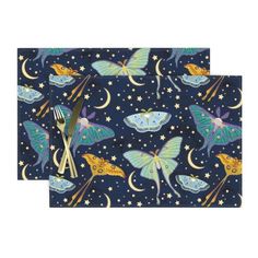 two placemats with butterflies and stars on them, one has fork and knife