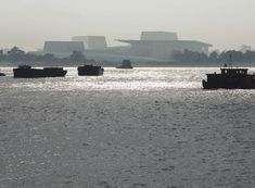 several boats floating on top of a large body of water