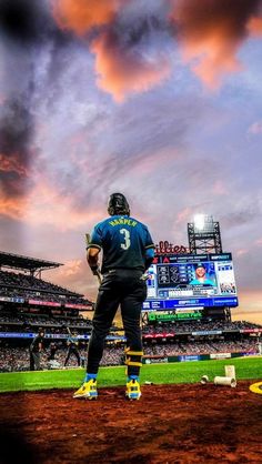 a baseball player standing on top of a field next to a stadium filled with people