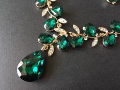 "** This listing comes with a necklace together with a pair of matching studs at back design earrings. ** Featuring clear rhinestones crystals and green glass stones and finished with gold plated cable chain. Just lovely and romantic!! Color: gold plated with clear rhinestone crystals and green glass stones Size: necklace measures around 19.25\" long x 3\" drop and earrings around 1.25\" long x 0.4\" width ** Please note we need to take around 5 days to make it. Please be patient. ** Item ship o Green Crystal Necklace For Wedding, Green Crystal Emerald Necklace For Wedding, Green Crystal Jewelry With Rhinestones, Green Crystal Jewelry Sets With Rhinestones, Green Crystal Jewelry Sets With Jewels, Green Crystal Rhinestone Jewelry Sets, Elegant Green Jewelry Sets With Rhinestones, Elegant Green Rhinestone Jewelry Sets, Green Crystal Rhinestone Necklace