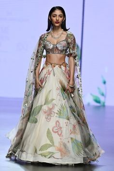 Ivory lehenga with floral print in a flowy silhouette, embellished by sequins and cut-out waist. Comes with matching blouse and dupatta. - Aza Fashions Bohemian Cream Wedding Sets, Floral Print Floor-length Sharara For Wedding, Wedding Floral Print Saree Set, Wedding Choli With Floral Print And Traditional Drape, Wedding Floral Print Choli With Traditional Drape, Traditional Wedding Choli With Floral Print, Elegant Floral Print Lehenga For Reception, Bohemian Floral Print Choli For Wedding, Bollywood Style Floral Print Wedding Sets