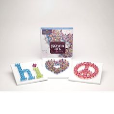 three different colored beads are in front of a box with the words stitch art on it