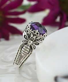 This stunning Alexandrite, Sky Blue Topaz or Amethyst Gemstone Sterling Silver Filigree Queen Bee Design Women's Dainty Cocktail Ring is the perfect accessory for special occasions. The ring features a beautiful Alexandrite gemstone set in a delicate sterling silver filigree design inspired by the graceful queen bee. The queen bee design adds a touch of whimsy and charm to the piece, making it a great choice for those who appreciate unique and playful jewelry. The dainty size of the ring makes i Luxury Sterling Silver Gemstones With Accents, Filigree Rings, Playful Jewelry, Purple Band, Bee Design, Filigree Design, Sterling Silver Filigree, Purple Stones, Gifts For Your Girlfriend