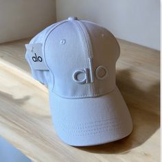 Questions? Leave A Comment Below! (1) White Cap For Sale Alo Yoga Alo Cap, Alo Hat, White Caps, Yoga Accessories, Caps For Sale, Alo Yoga, Off Duty, Leave A Comment, New Color