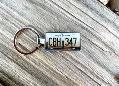 a license plate keychain that says happy birthday cbhi347 on it