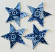 four blue stars are arranged on a white surface