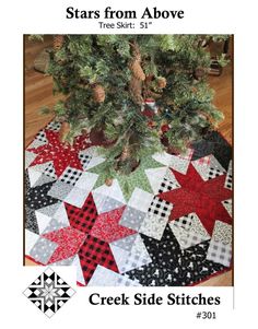 a quilted christmas tree skirt with stars on the front and bottom, along with an image of a pine tree