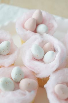 some cupcakes with marshmallows in them on a plate