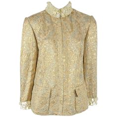 Dolce & Gabanna Silk Gold Brocade Jacket with mother of pearl trim - 44 This spectacular jacket is a must have for every fashionista. The fabric of the jacket has a light sage background with gold and rose gold detail, the cuffs and neckline have a thick grosgrain ribbon with multiples rows of mother of pearl detail. The jacket has 2 flap pockets with interior snaps and has hidden hook and eyes all along the front. This jacket is in very good condition. Size 44 Measurements: Shoulder to Shoulder Brocade Jacket, Dolce Gabbana Jacket, 1950 Fashion, Gold Jacket, Gold Brocade, Stefano Gabbana, Gold Silk, Silk Brocade, Silk Jacket