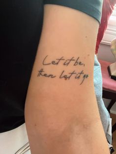 a woman with a tattoo on her arm that says, let it be written in cursive writing