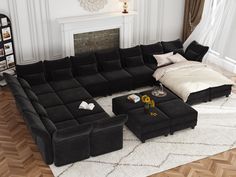 a living room with a large black couch and ottoman