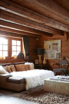 a living room filled with furniture and wooden walls