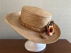 "Darling Ladies' 100% Straw Boat Hat Made In Phillipines. 1970s-80s. Its hat band is a beautiful straw braid with a very autumn-like dried flower arrangement on the brim. The barim is  3-4\" wide around the hat and measured inside the crown it measures 8\" front to back and 6 ½\" side to side. There is no maker indicated, but great condition and very nice.  $19.00" Boat Hat, Holiday Christmas Tree, Hat Band, Dried Flower, Hat Making, Flower Arrangement, Boating, The Crown, Sun Hats