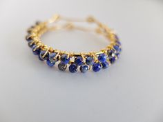 These beautiful fine hoop earrings have beautiful faceted blue Lapis Lazuli and gold filled wire . The gemstones are deep blue color. The genuine beads are wire wrapped around gold filled hoops. the gemstones are faceted genuine lapis lazuli and they are completely handwrapped by me with gold filled wire Diameter of the hoops is 3,00 cm- total diameter is 3.50 cm The round shaped, faceted stones measure 2.5 mm approximately please note that you will receive the exact stones of the photes above T Handmade Blue Hoop Earrings In 14k Gold Filled, Handmade Blue 14k Gold Filled Hoop Earrings, Blue Nickel-free 14k Gold-filled Hoop Earrings, Blue 14k Gold-filled Wire Wrapped Jewelry, Blue 14k Gold Filled Wire Wrapped Jewelry, Blue Small Hoop Wire Wrapped Earrings, Blue Wire Wrapped Small Hoop Earrings, Blue Wire Wrapped Hoop Earrings For Gift, Small Blue Wire Wrapped Hoop Earrings