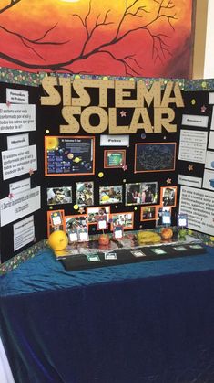 a table topped with pictures and information about the solar system