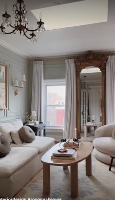 a living room filled with furniture and a chandelier