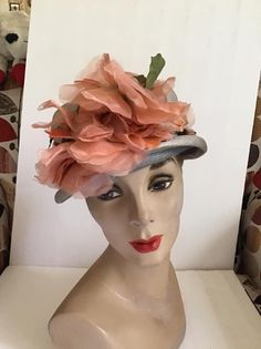 "Vintage 1950's 1960's light Gray Straw hat with Dark Peach flowers. The label is *Grayce Hats*. Does have condition issues and will be sold as is. (SEE PIX). *MORE INFORMATION BELOW* CONDITION: Has discoloration around the inside brim in the front on the straw and on the band/ribbon (SEE PIX). On the inside band on the right side there is a small dark spot. In the back of the hat on the brim area there is some wear. This appears to be from where the hatpin was always used (SEE PIX). Sold As Is! Vintage Orange Hat With Curved Brim, Vintage Gray Hat, One Size, Vintage Gray Hat, One Size Fits Most, Vintage Gray Hat, Vintage Mini Hats With Short Brim For Spring, Vintage Cloche Hat For Spring, Retro Brimmed Mini Hat For Spring, Vintage Gray Brimmed Hat, Vintage Spring Cloche Hat For Party