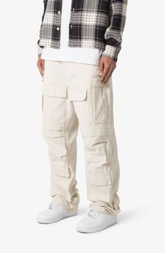 The ultrabaggy fit of these nonstretch cotton pants lets you move with ease all day long, while the cargo pockets keep all your essentials close at hand. 32 1/2" inseam; 9 1/2" leg opening Zip fly with button closure Front scoop pockets; cargo flap-patch pockets; back patch pockets 100% cotton Machine wash, tumble dry Imported Cargo Pants Outfit Men, Pants Outfit Men, Cotton Cargo Pants, Baggy Cargo Pants, Cargo Pants Outfit, Ripstop Fabric, Cotton Pants, Baggy Fits, Cargo Pants