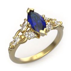 a gold ring with a blue and white stone surrounded by small diamond accents on the sides