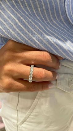 a woman's hand wearing a diamond ring