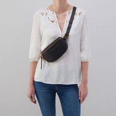 Soft to the touch with a pebbled texture, this hand-picked full-grain hide is a casual leather that gets more beautiful over time. It has an adjustable strap going from belt bag to crossbody, an easy zip closure and just enough room inside for the essentials. Features 8.5" W x 5.5" H x 1.5" D Sandlewood Lining Interior Front: 3 credit card slots; Interior Back: Zip pocket Fits your phone Old English Brass Hardware Zip Closure 30" - 49” Strap Drop Solid leather single strap Wear as a belt bag or Chic Shoulder Belt Bag With Belt Loops, Black Leather Belt Bag With Zipper Closure, On-the-go Shoulder Belt Bag With Pockets, Leather Belt Bag With Large Capacity For On-the-go, Black Belt Bag With Zipper Pocket, Shoulder Style, New Dimension, Leather Belt Bag, Adjustable Belt, Old English