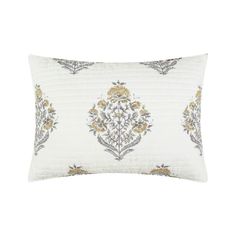 a white pillow with gold and silver flowers on it