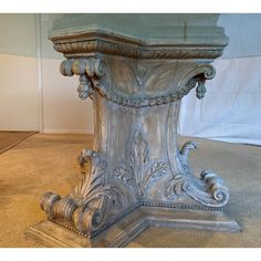 an ornate silver pedestal on the floor