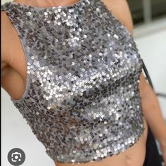 Express Sequin Halter Crop Top! It Is Super Trendy And Can Be Worn With Leggings, Jeans, Pants, Or Shorts Making It Very Versatile. The Inside Is A Soft Material And Is 100% Polyester Making It A Comfy Yet Stylish Addition To Your Wardrobe. Perfect For Upcoming Christmas Parties & New Years Silver Crop Top For Summer Party, Elegant Silver Crop Top For Party, Fitted Silver Sleeveless Crop Top, Silver Sleeveless Crop Top For Evening, Silver Sleeveless Crop Top For Night Out, Silver Fitted Crop Top For Night Out, Silver Crop Top For Party Season, Silver Sequined Sleeveless Crop Top, Silver Crop Top For Night Out In Spring