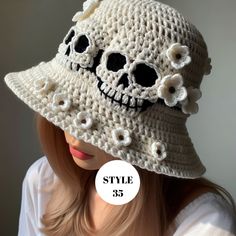 a woman wearing a white crocheted skull hat