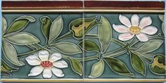 two tiles with flowers and leaves on them