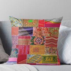 a colorful patchwork pillow sitting on top of a couch