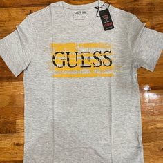 Brand New Authentic Guess Slim Fit Never Worn Yellow Cotton Tops With Logo Print, Yellow Logo Print Casual T-shirt, Yellow Casual T-shirt With Logo Print, Casual Yellow T-shirt With Logo Print, Spring Yellow Shirt With Letter Print, Casual Mustard Top With Graphic Print, Mustard Casual Top With Graphic Print, Yellow Graphic Tee Shirt With Logo Print, Yellow Graphic Tee With Logo Print