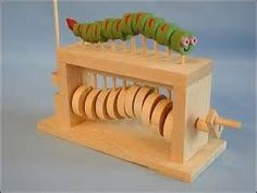 a wooden toy that is shaped to look like a caterpillar on a spinning wheel