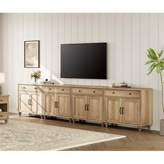 a living room scene with focus on the entertainment center and large screen tv mounted to the wall