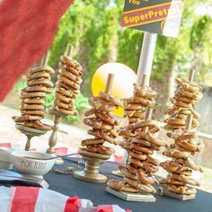 there are many donuts stacked on top of each other in front of a sign