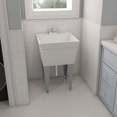 a white sink sitting under a window in a bathroom