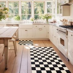 a black and white checkered rug in a kitchen