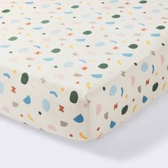 a white sheet with multicolored dots on it