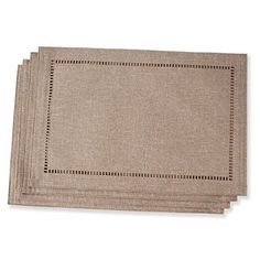 four placemats with stitching on the edges, one brown and one beige