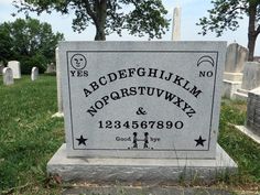 a headstone in the middle of a cemetery with an embossed name on it