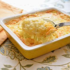 a fork in a casserole dish on a table