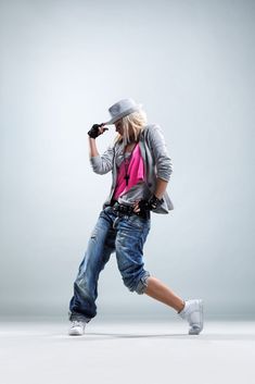 a man in jeans and a hat is dancing